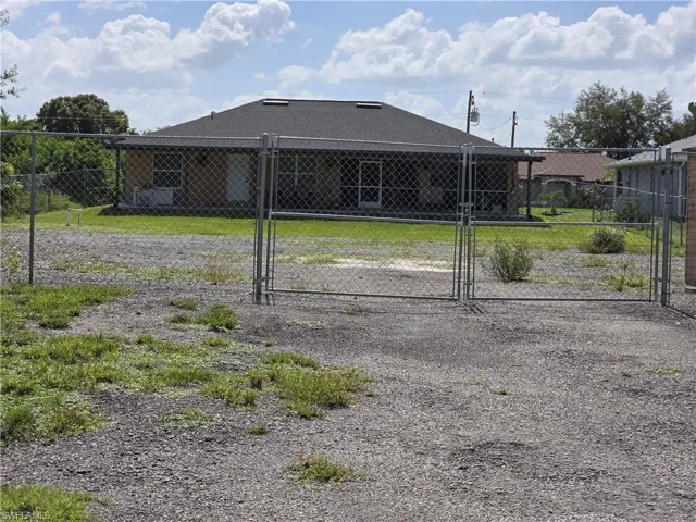 View of front facade with a gate and a patio