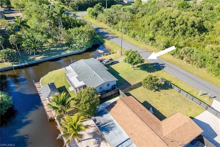 Birds eye view of property with a water view
