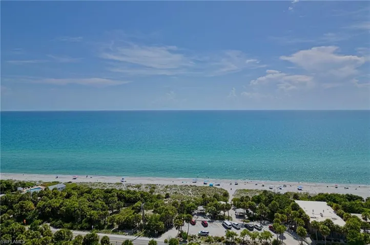 Drone / aerial view featuring a view of the beach and a water view