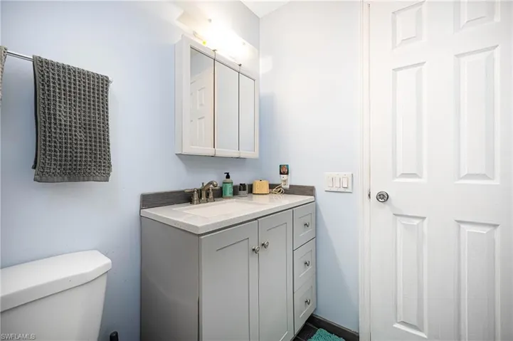 Half bath featuring toilet and vanity