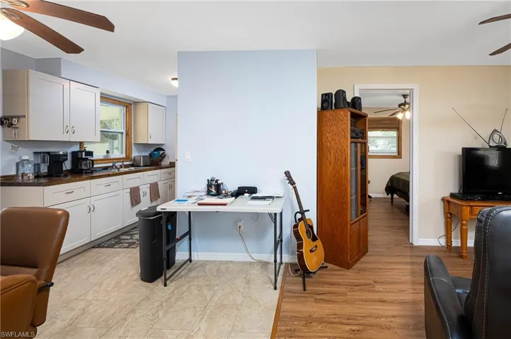 Kitchen featuring dark countertops, plenty of natural light, a ceiling fan, and a sink