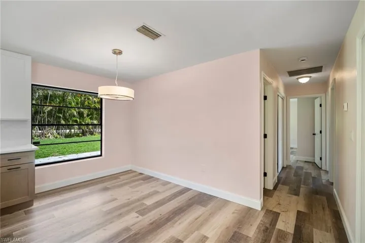 Unfurnished dining area with light wood-type flooring and a wealth of natural light
