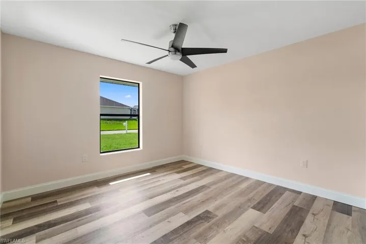 Spare room with light wood-type flooring and ceiling fan