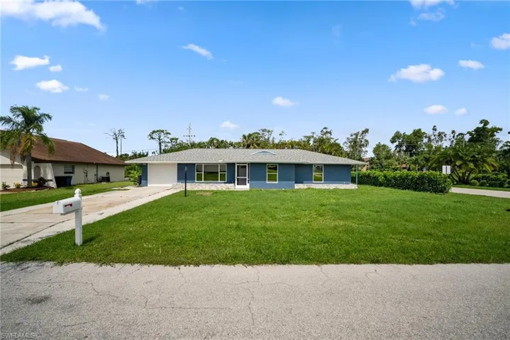 Single story home with a front lawn