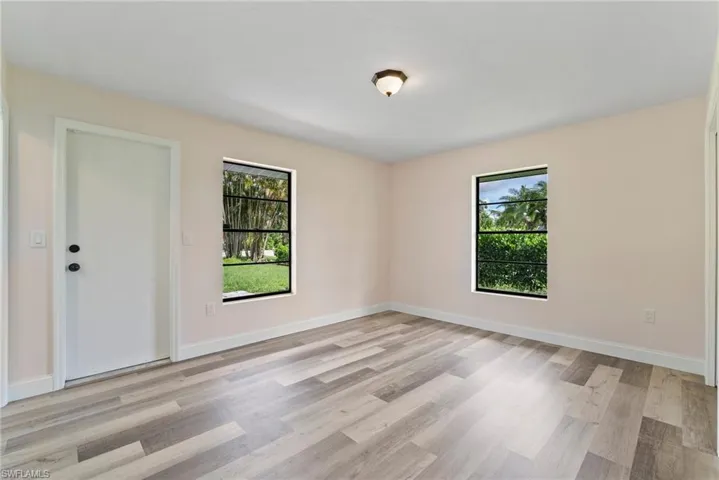 Empty room with light hardwood / wood-style floors