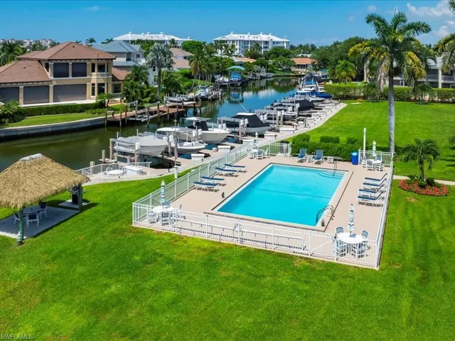 Community pool with a water view and a patio area