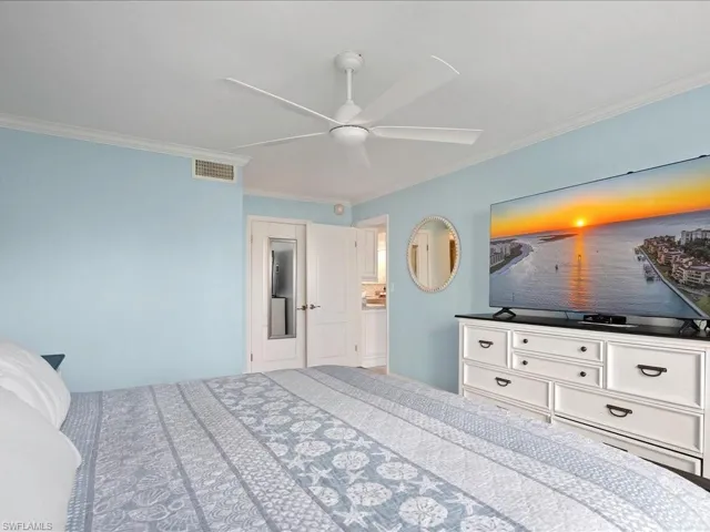 Bedroom featuring ornamental molding and a ceiling fan