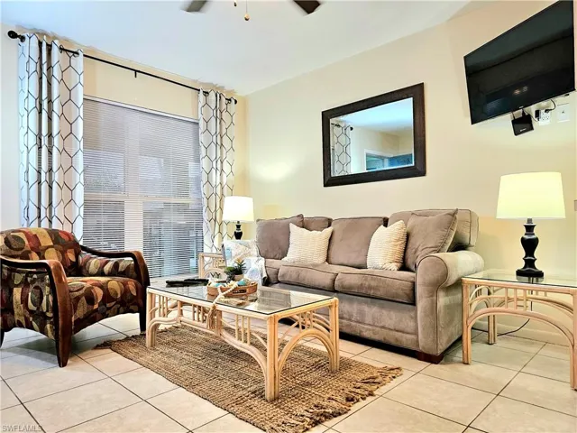 Tiled living room featuring ceiling fan