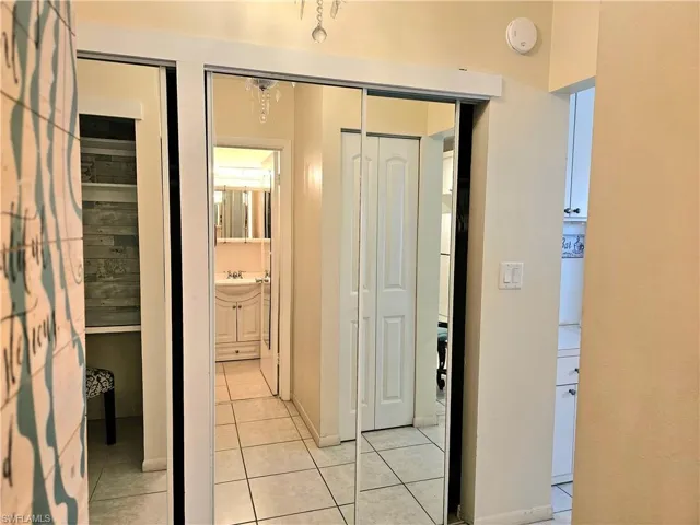 Hall with sink and light tile floors