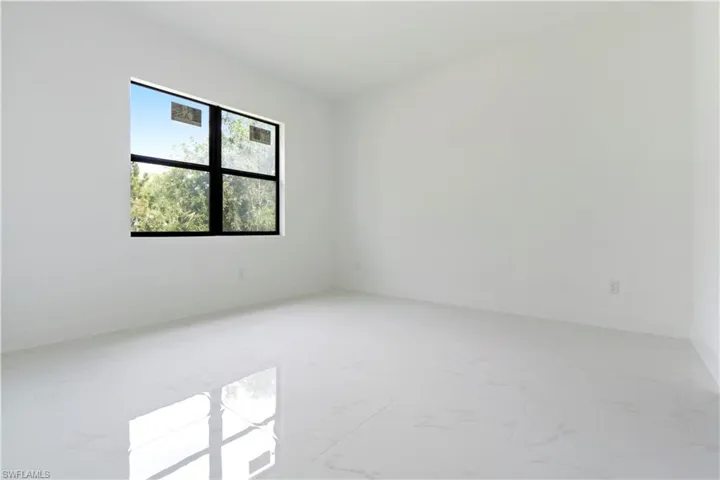 Empty room with light marble finish flooring and baseboards