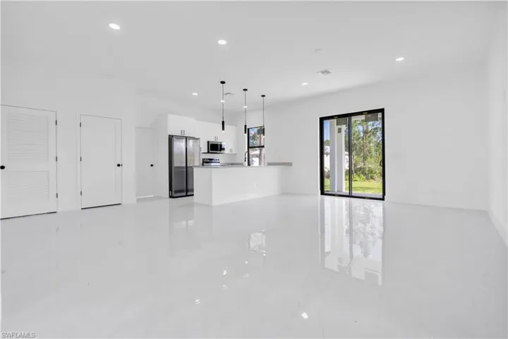 Unfurnished living room with recessed lighting and light marble finish flooring