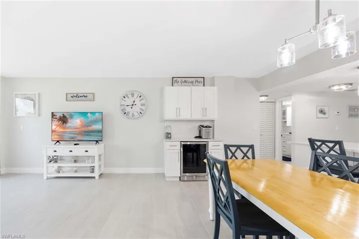 Dining room with beverage cooler and baseboards