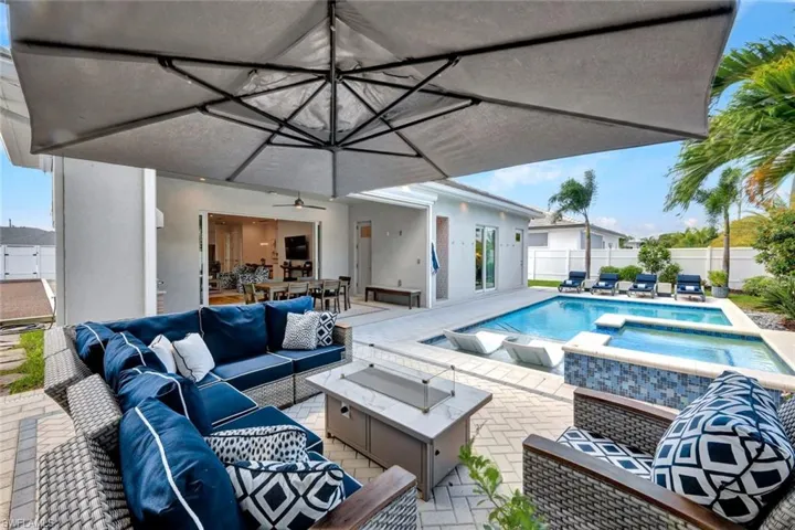 Resort style pool area with bocce court and outdoor shower/bathroom + additional storage for pool essentials.