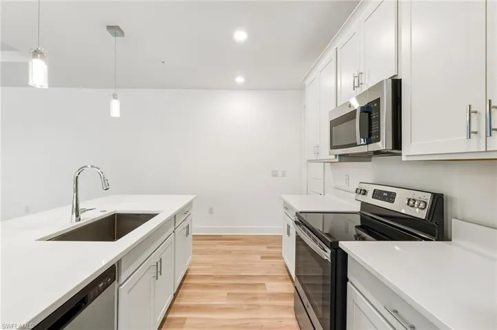 White and bright kitchen features one bowl sink