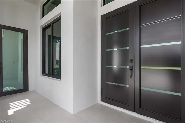 Doorway to property with stucco siding and french doors