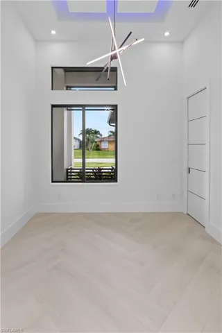 Empty room with recessed lighting, a chandelier, and light wood-style flooring