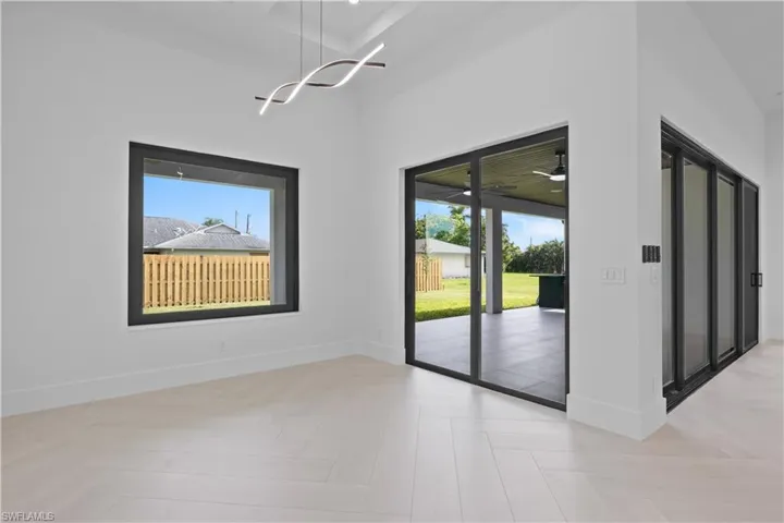 Unfurnished dining area featuring healthy amount of natural light and a chandelier