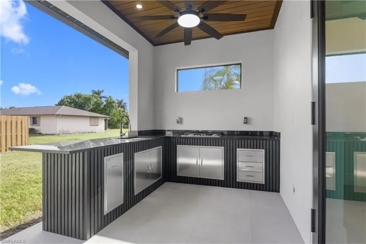 View of patio / terrace with an outdoor kitchen and ceiling fan