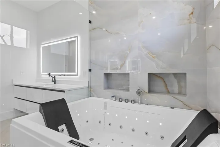 Bathroom with a whirlpool tub and vanity