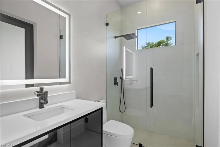 Full bath with vanity and a stall shower