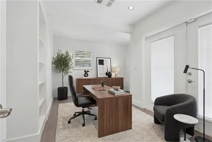 Bright interior space featuring recessed lighting, wood-finish flooring, and built-in shelving
