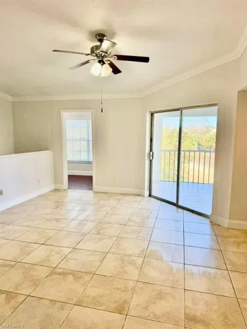 Unfurnished room with a ceiling fan, crown molding, healthy amount of natural light, and light tile patterned floors
