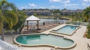 Community pool featuring a patio area, a gazebo, a water view, and a residential view