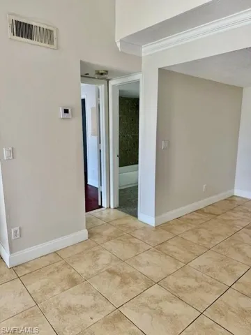 Unfurnished room with baseboards and light tile patterned floors