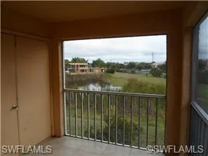 Balcony featuring a water view and a sunroom