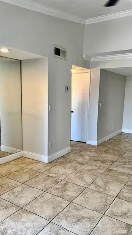 Empty room featuring baseboards and ornamental molding