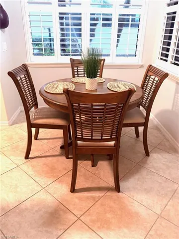 Dining space with light tile patterned floors