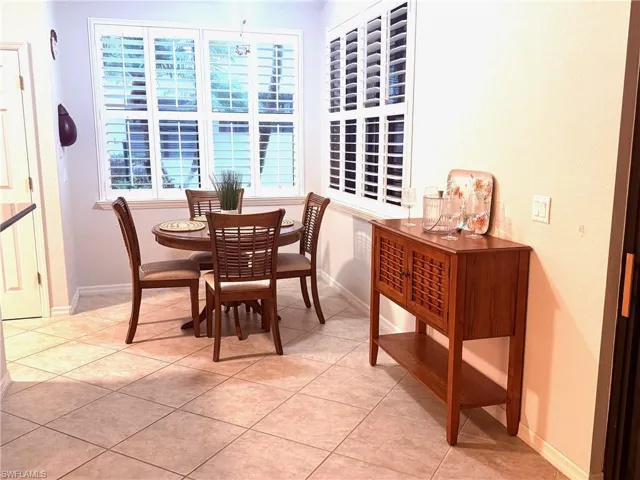 Dining space featuring light tile patterned floors