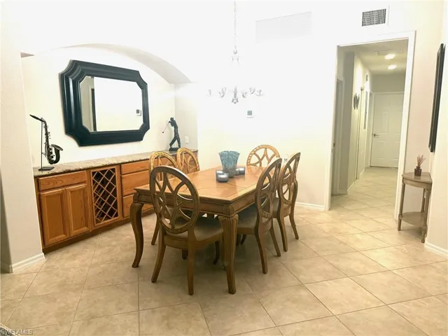 Dining space with a chandelier and light tile patterned floors