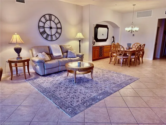 Living room with an inviting chandelier and light tile patterned floors