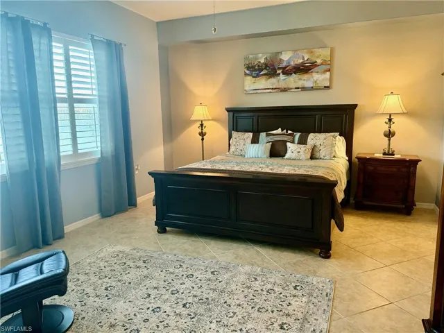 Bedroom with light tile patterned flooring