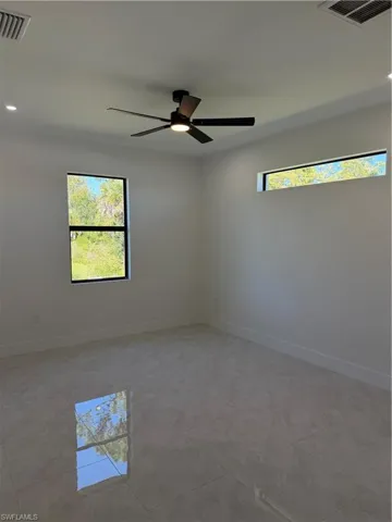 Empty room with recessed lighting, healthy amount of natural light, and a ceiling fan