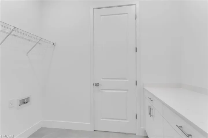 Laundry room with washer hookup and cabinet space