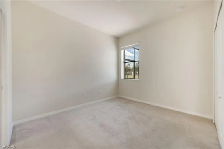 Unfurnished room featuring light colored carpet