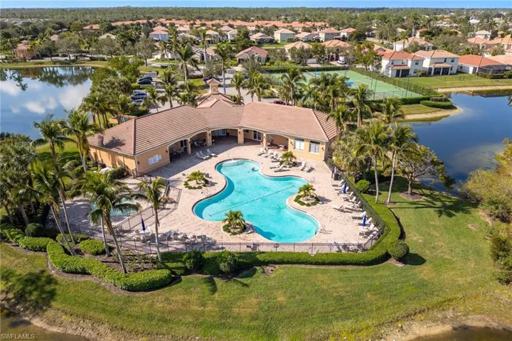 View of swimming pool with a yard, a patio, and a water view