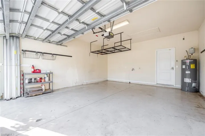 Garage with a garage door opener and electric water heater
