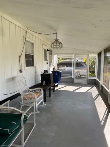 Unfurnished sunroom with lofted ceiling
