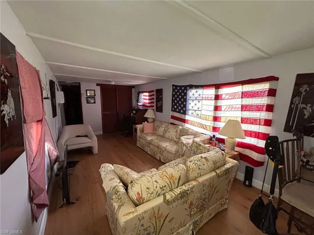 Living room with wood-type flooring