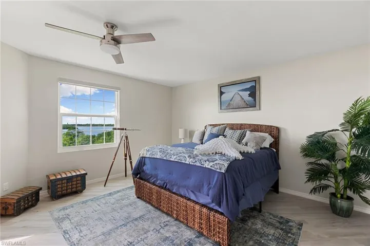 Bedroom with ceiling fan and hardwood / wood-style floors