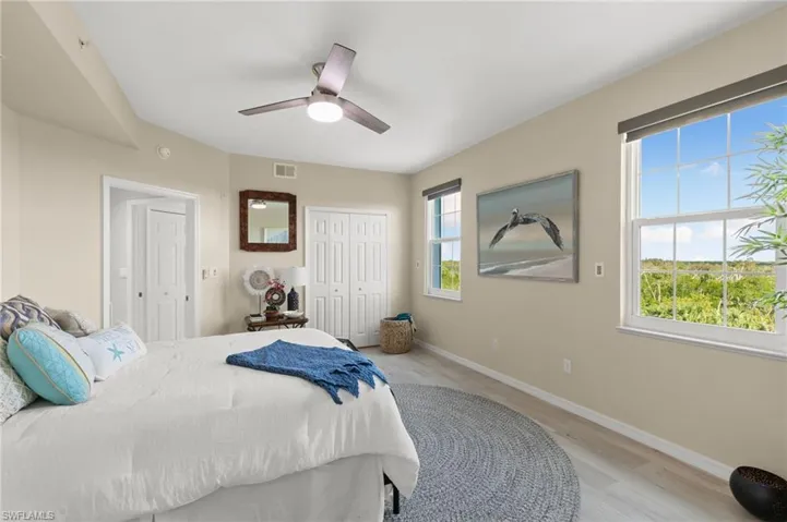 Bedroom with light hardwood / wood-style flooring and ceiling fan