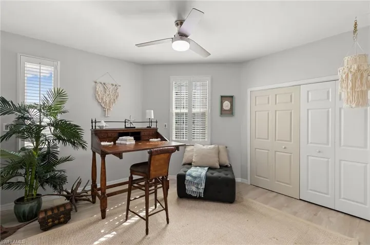 Office space with ceiling fan, light hardwood / wood-style flooring, and a healthy amount of sunlight
