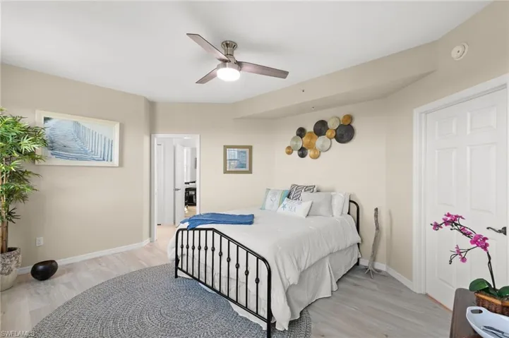 Bedroom with ceiling fan and light hardwood / wood-style floors