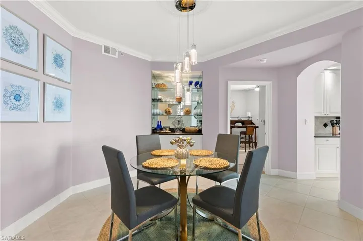 Tiled dining area featuring ornamental molding