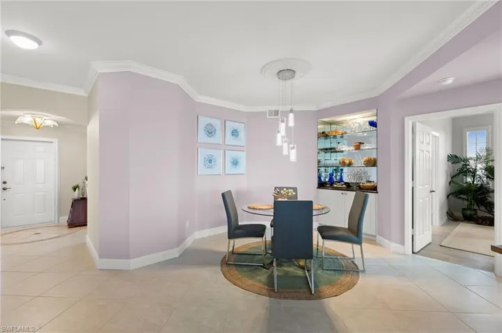 Tiled dining area with crown molding
