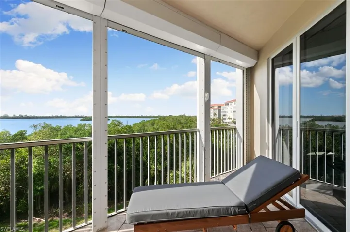 Sunroom / solarium with a water view and a healthy amount of sunlight