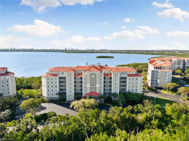 Birds eye view of property with a water view